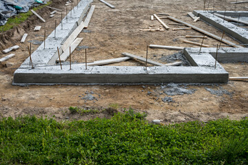 New housing development construction site, foundation cement pour started with iron rebar sticking...