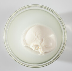 Fresh Italian cow milk cheese burrata made from mozzarella and cream in brine..