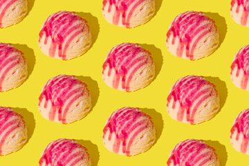 Pink strawberry ice cream pattern on yellow background. Summer food concept. Minimal isometric layout. Ice cream scoop aesthetic idea.
