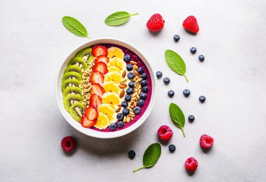 A bowl of fruit and nuts on a table.