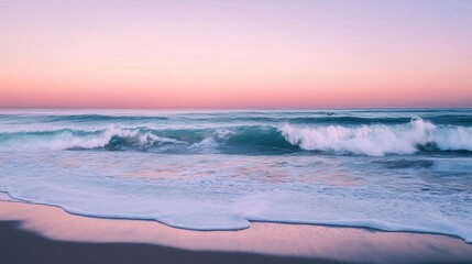 Naklejka premium Pastel colored ocean waves crashing on a sandy beach at dawn.