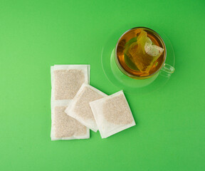 Herbal tea sachet in cup, hot water with chamomile and Hypericum or St. John's wort teabag