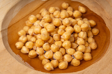 Soaked chickpeas, chick pea in water, swollen wet Cicer arietinum fruits, garbanzo beans cooking
