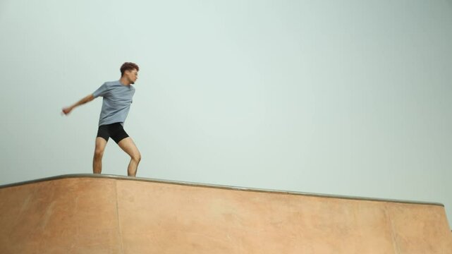Young man performing parkour moves on a rooftop