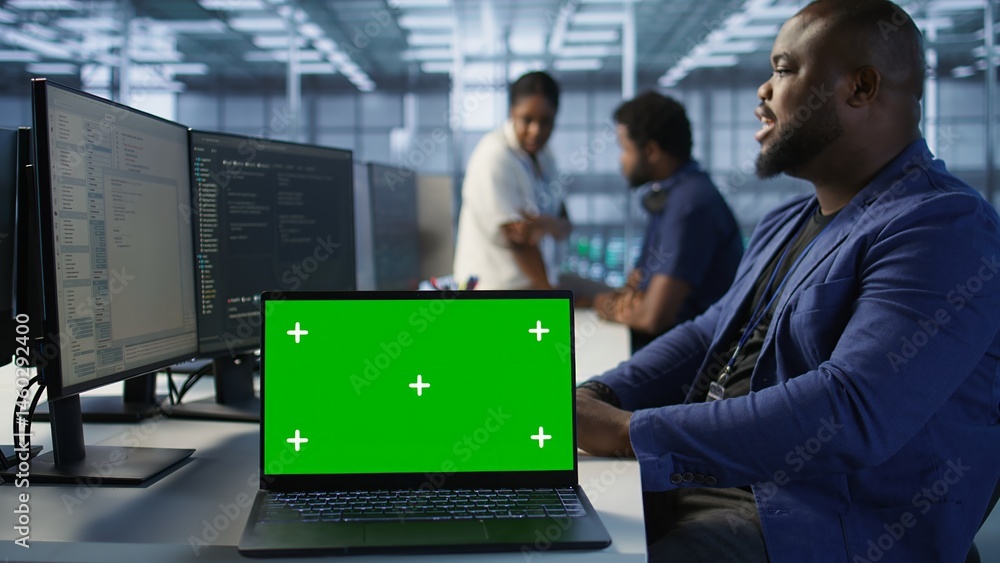 Poster data center technician using chroma key laptop, maintaining company network infrastructure. server h