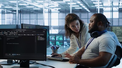 Manager showing admin how to finish tasks in data center providing resources for different...