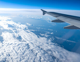 Aerial View Of Clouds And Ocean From Airplane Window