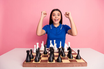 Excited young woman celebrating a chess victory in a vibrant setting