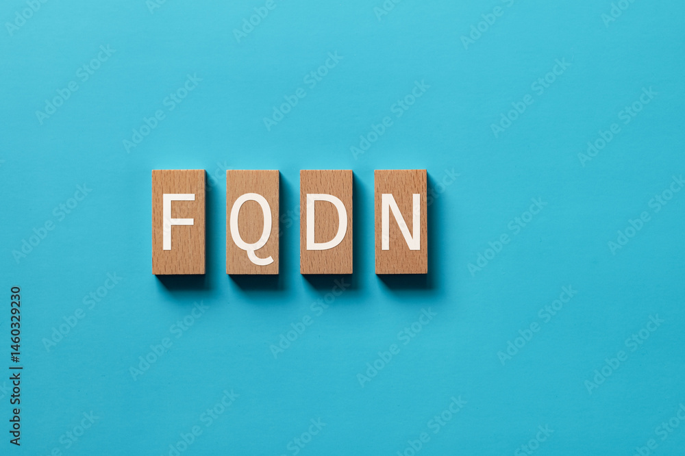 Aufkleber there is wood block with the word fqdn. it is an abbreviation for fully qualified domain name as eye