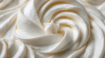Obraz premium A close, up on whipped cream or off, white vanilla pudding with swirls and spreads filling the frame, selective focus