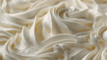 Obraz premium A close, up on whipped cream or off, white vanilla pudding with swirls and spreads filling the frame, selective focus