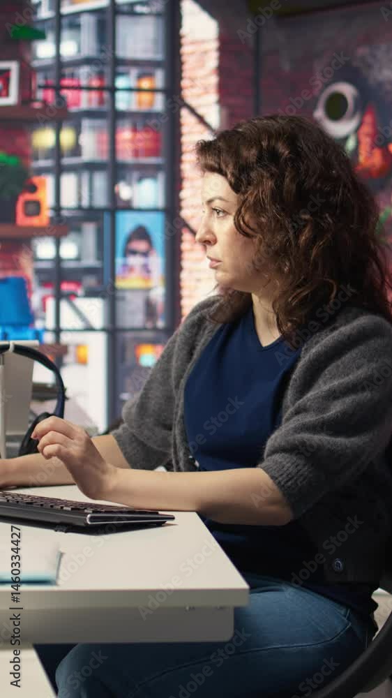 Fototapete Vertical Video Female programmer developing app and software algorithm on pc, working at creative agency. Engineer uses digital tools and focuses on java script engineering and coding, IT specialist