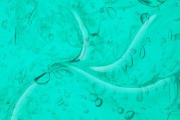 Cream gel aqua green blue transparent cosmetic sample texture with bubbles background