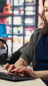 Vertical Video Software developer at agency office coding on her computer, creating a software and works on implementing algorithms. IT expert building applications with a programming interface
