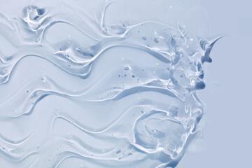 Liquid water serum gel smudge cosmetic blue textured background.Cosmetic skin care beauty product