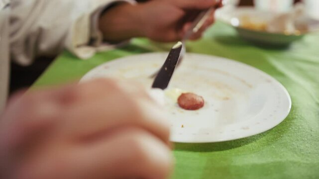 Hungry Depressed Chef Man Divides A Sausage On His Plate For His Meager Dinner