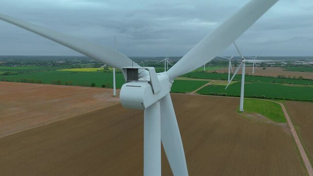 Aerial drone view renewables wind turbines energy electricity gas coal fossil fuels green rural fields generation England UK Biggleswade 