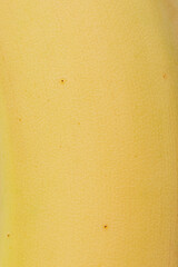 Texture of yellow banana as a background macro photo. Banana skin. Tropical fruit.