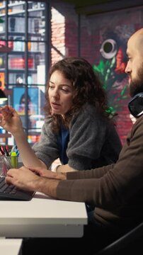 Vertical Video Graphic artists use architectural software on PC to create a detailed 3D render of a home interior. Team employ program to configure furniture and design elements for virtual layout