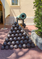Principality of Monaco, France - July 9, 2024: Place du Palais, Palace Square. Cannon balls and historic cannon at NW corner.