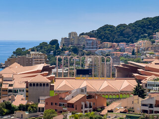 Principality of Monaco, France - July 9, 2024: Place du Palais, Palace Square. Looking over the south rampart shows lots of new buildings, forest and sea. Bows above Sport Stadium Louis II