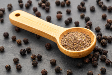Piper nigrum - Organic ground black pepper on a spoon