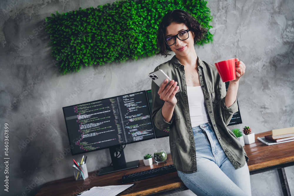 Poster young professional programmer working remotely in a stylish office with a relaxed and focused vibe