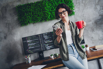 Young professional programmer working remotely in a stylish office with a relaxed and focused vibe