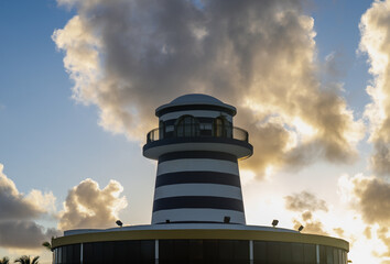 tower with nautical stripe design against the blue sky with colourful clouds on a sunrise