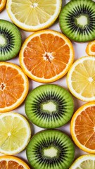 Obraz premium Grid pattern of sliced citrus fruits including lemon, orange, and kiwi