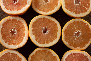 A top down view of a layer of grapefruit slices, as a background.