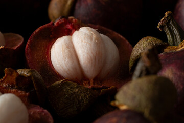 A closeup view of some opened mangosteen fruit.