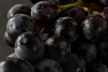 A closeup view of a cluster of black seedless table grapes.