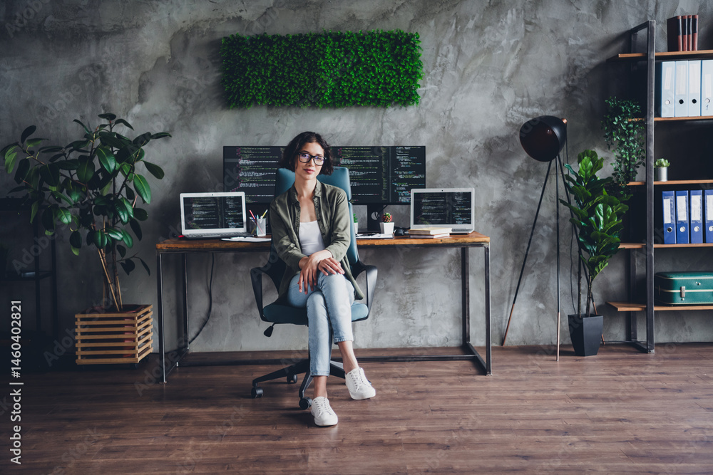 Aufkleber young female programmer working remotely in a stylish home office with multiple screens and organize