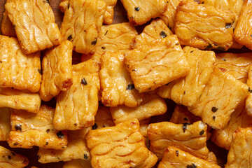 A top down view of a pile of crispy rice cracker snack, as a background.