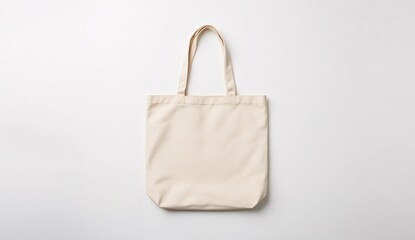 Flatlay beige totebag mockup on matte white surface with soft shadows in clean studio scene