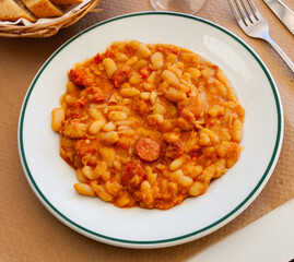 Delicious stewed beans with chorizo sausage pieces. Spanish cuisine
