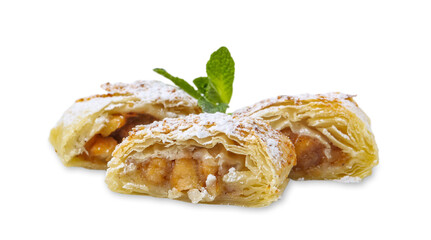 Pieces of tasty apple strudel with powdered sugar and mint isolated on white