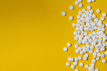 Sugar substitute, sweetener pills over yellow background. Food supplement. Diabetic, over weight, health concept. 