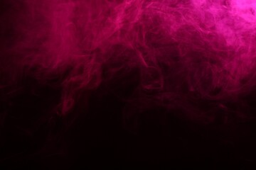 Beautiful smoke in pink light on dark background