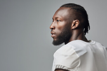 Fototapeta premium portrait of football player in light minimalist style showcasing their intense focus and determination