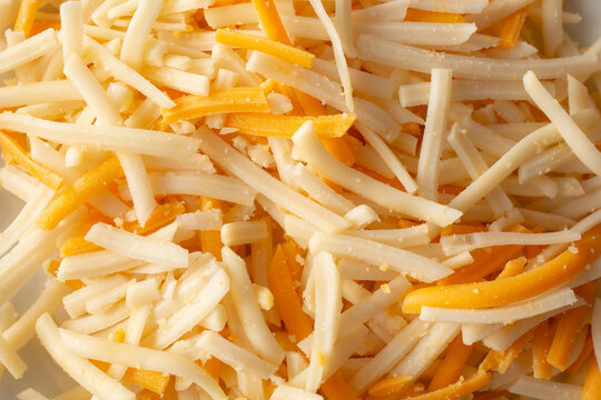A top down view of a pile of dairy-free shredded cheese, as a background.