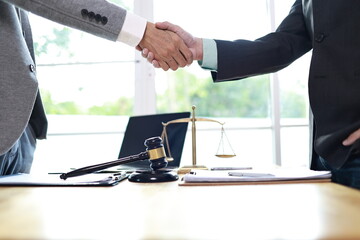 A male executive and female colleague discuss documents in a corporate office, demonstrating leadership, collaboration, and professional teamwork in a business agreement setting.