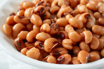 A closeup view of a bowl of black eyed peas.