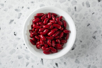 A top down view of some red kidney beans, in a bowl.
