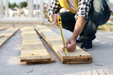 A diverse group of architects, engineers, and business professionals exchange a handshake indoors, symbolizing teamwork, success, and cooperation in a construction industry agreement.