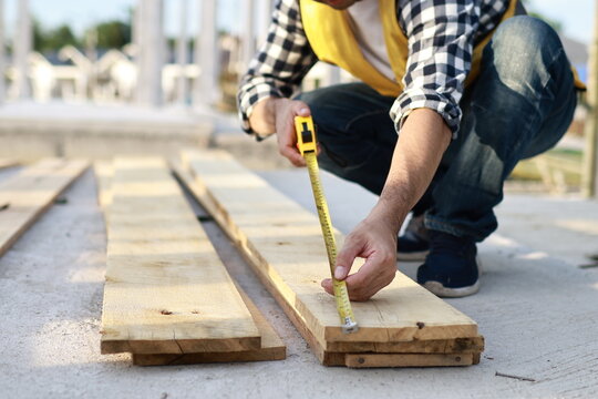 A diverse group of architects, engineers, and business professionals exchange a handshake indoors, symbolizing teamwork, success, and cooperation in a construction industry agreement.