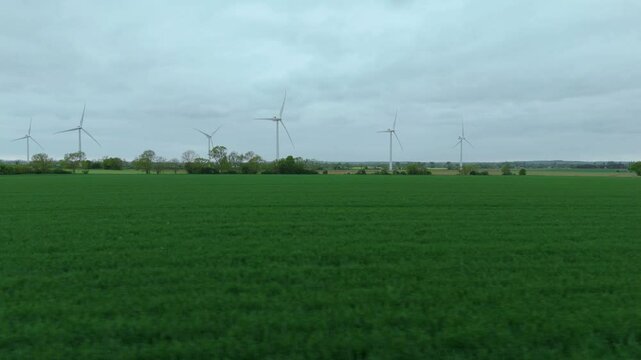 Aerial drone view renewables wind turbines energy electricity gas coal fossil fuels green rural fields generation England UK Biggleswade 
