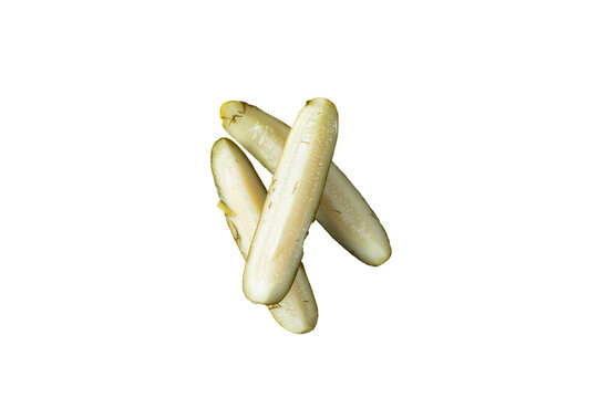 A top down view of a pile of pickle spears, against a white background.