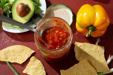 A top down view of a jar of salsa.